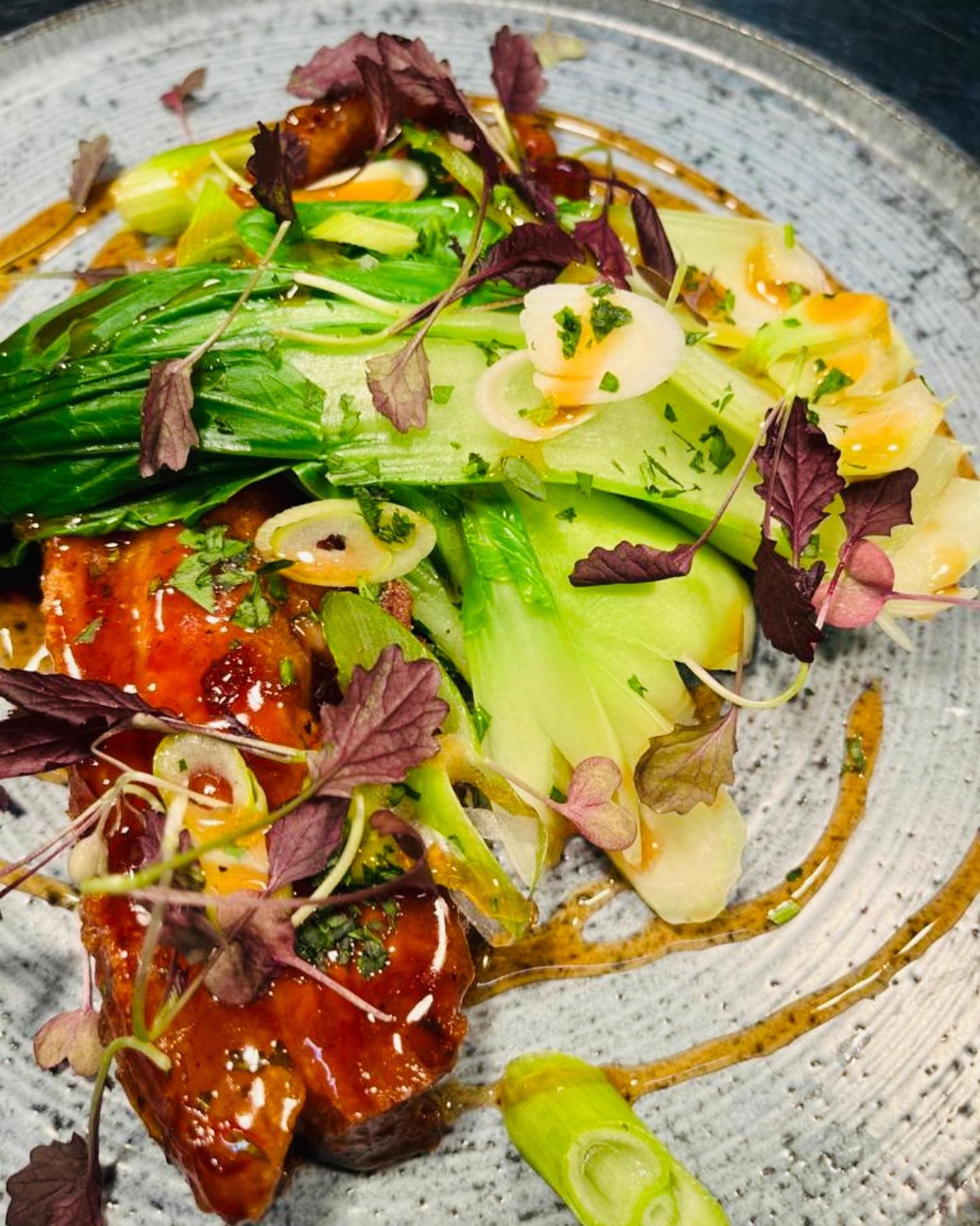 Glazed pork belly with pak choi, spring onion and micro herbs