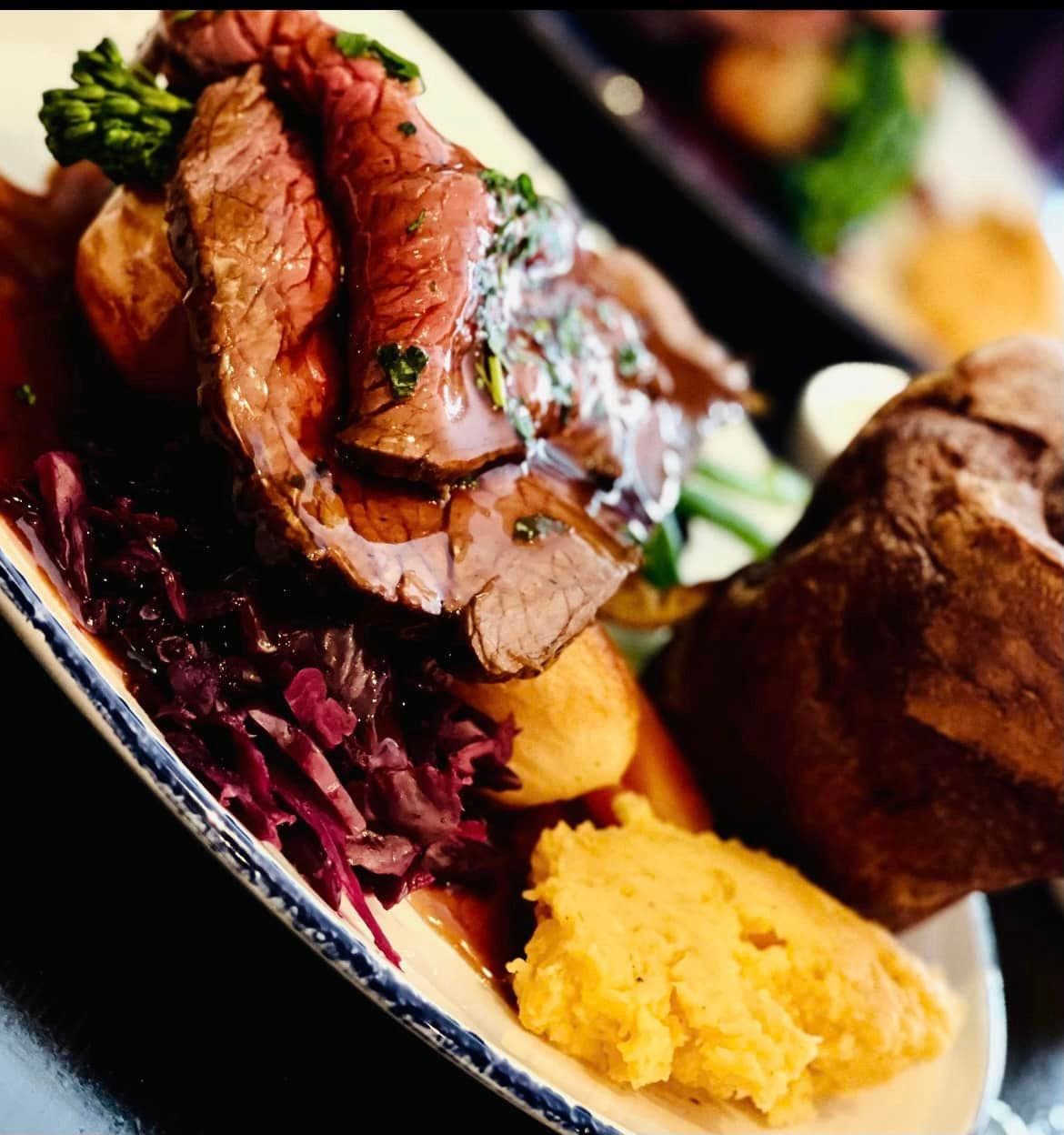 Sliced roast meat with braised red cabbage, broccoli and a swede purée